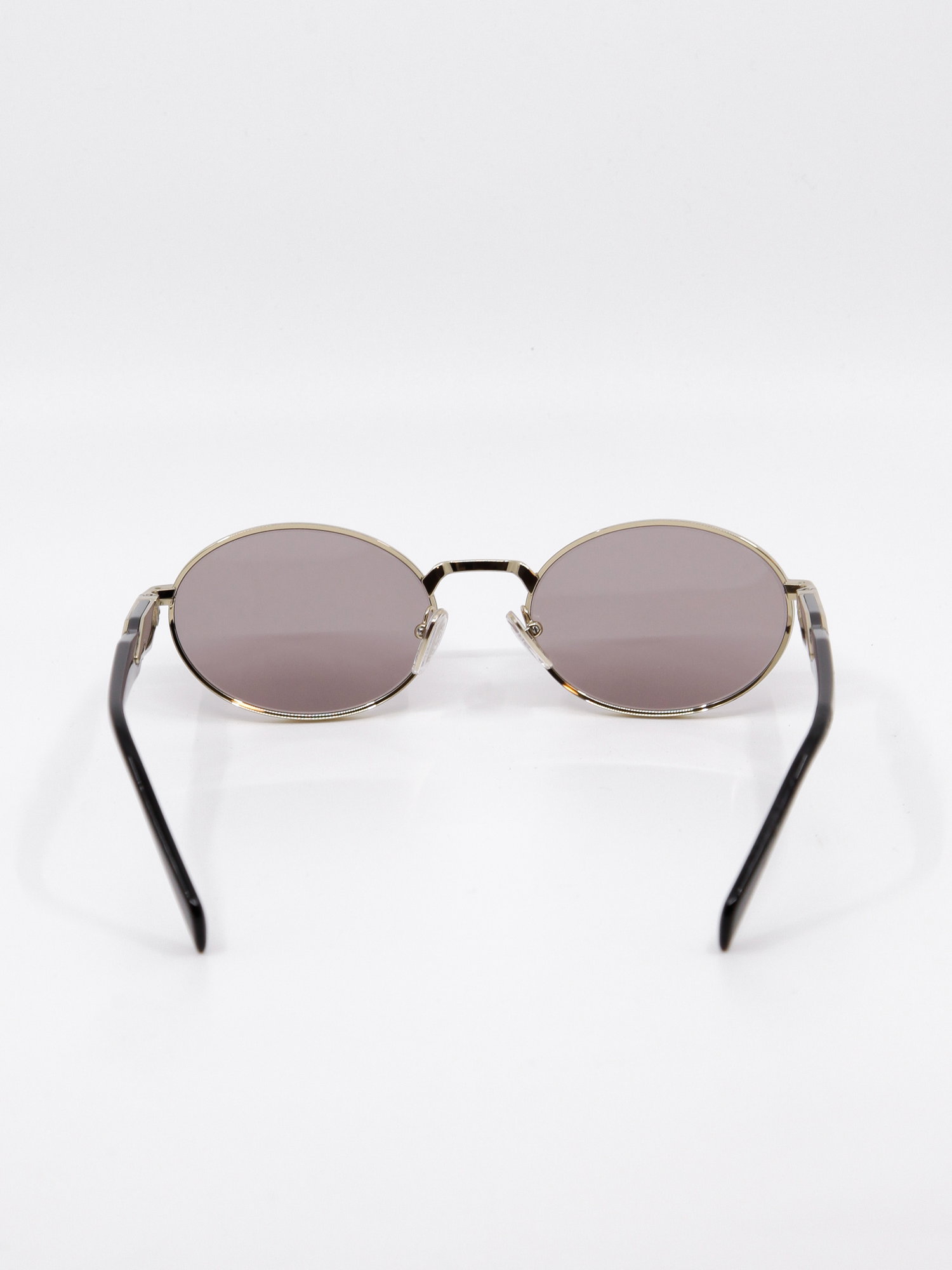 Oval metallsolbrille i gull med rosa glass
