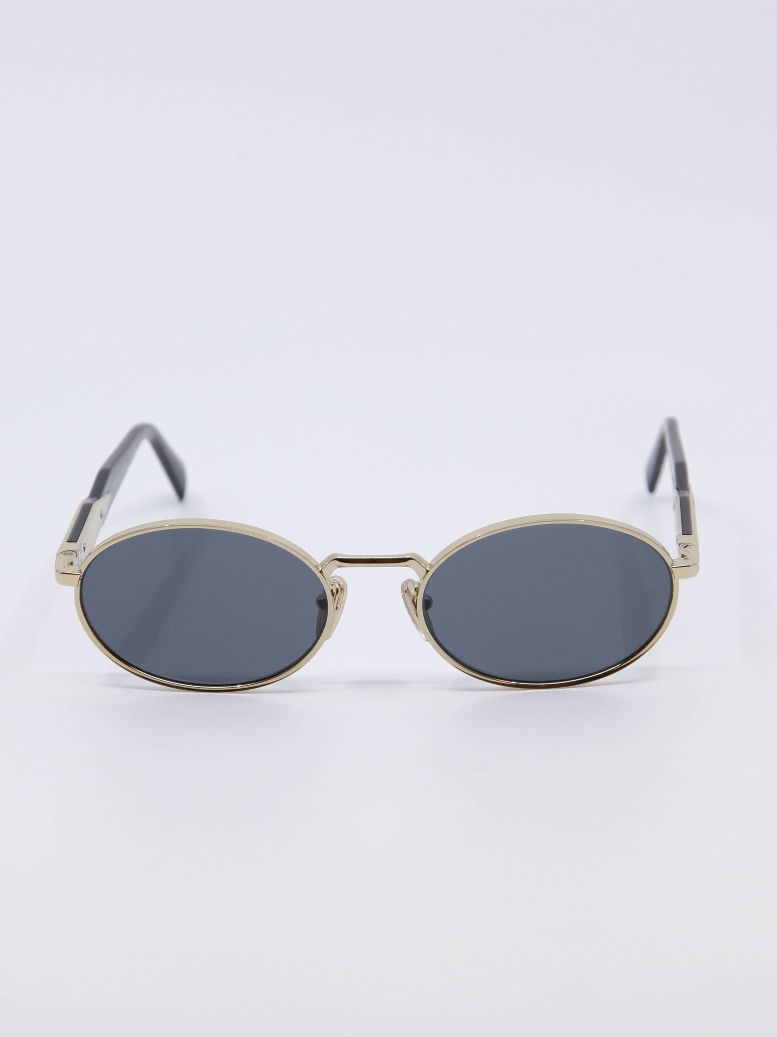 Oval metallsolbrille i gull med blå solbrilleglass