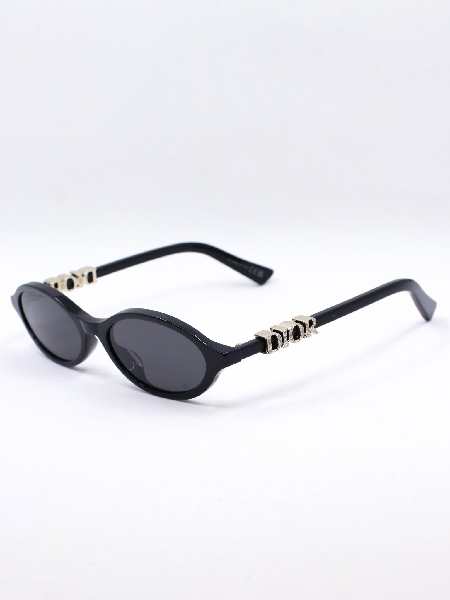 Svart oval solbrille med mørke glass