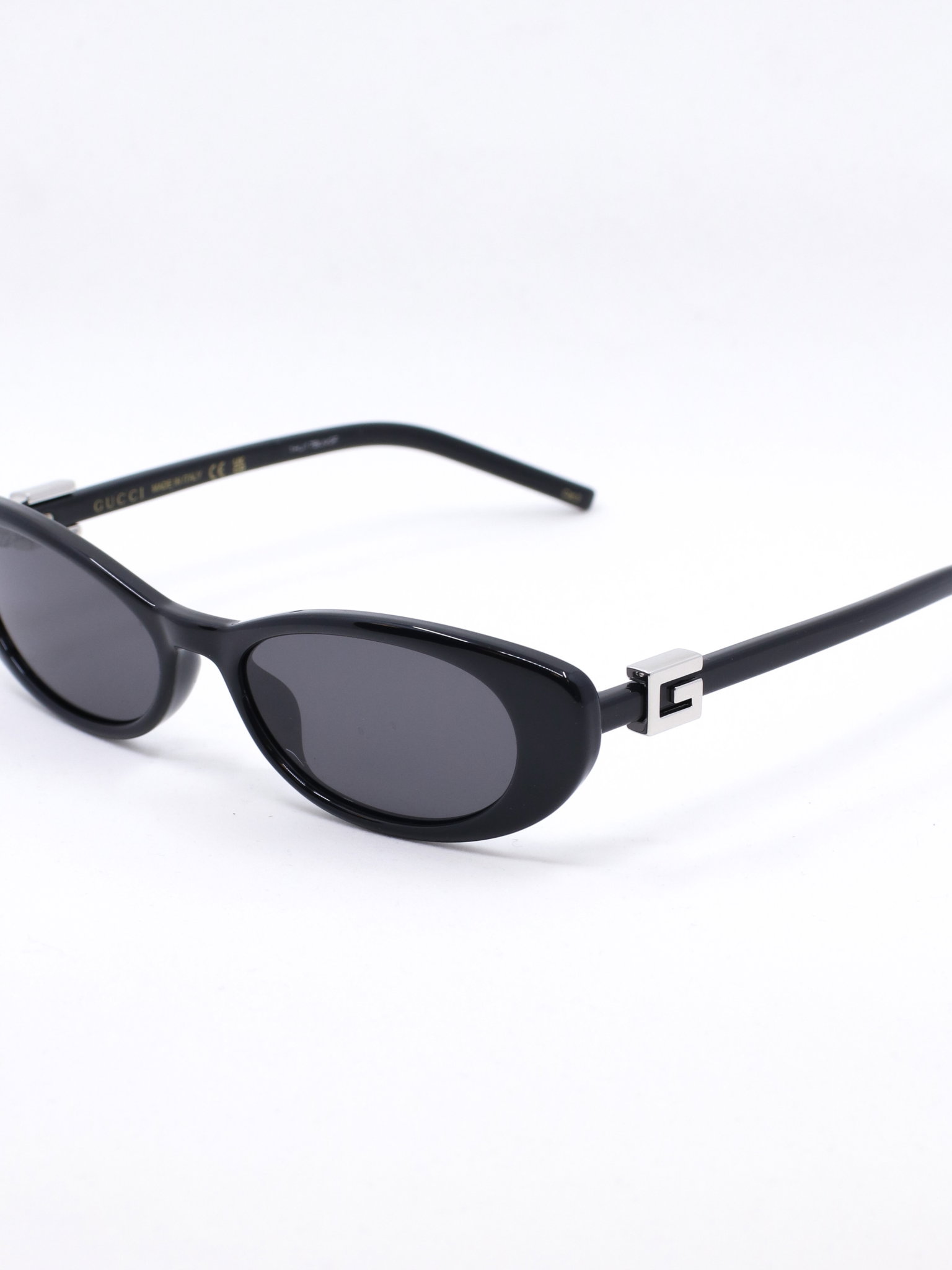 Smal solbrille med avrundet cateye fasong i fargen svart