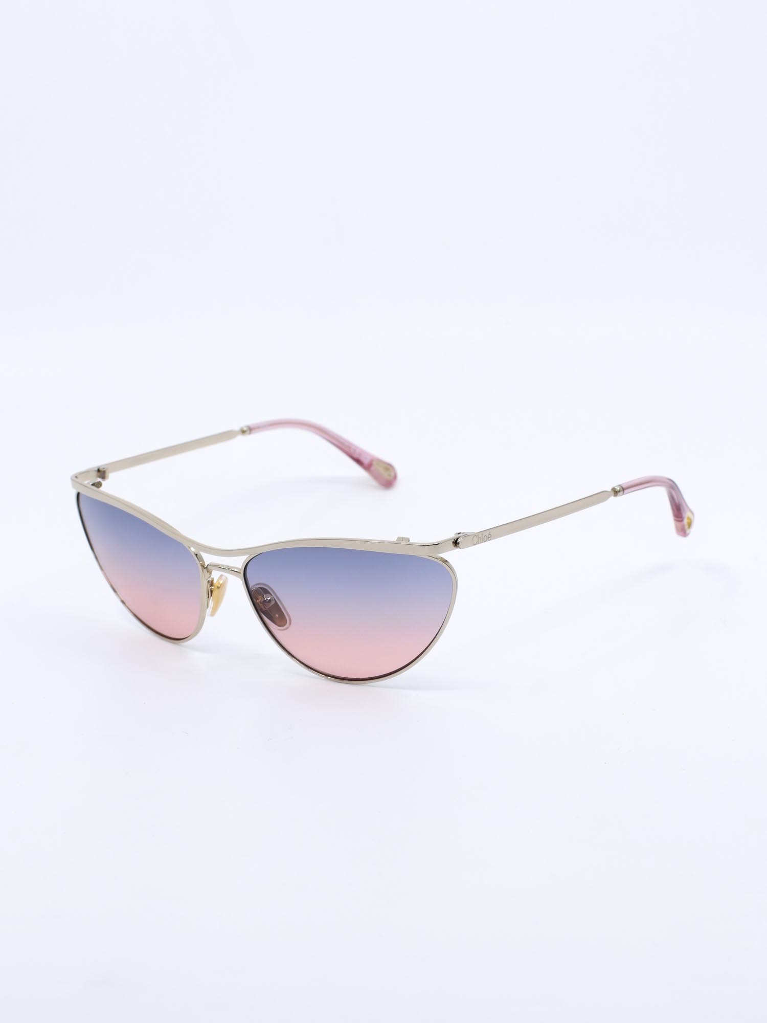 Metallsolbrille i gull med cateye fasong og rosa graderte glass