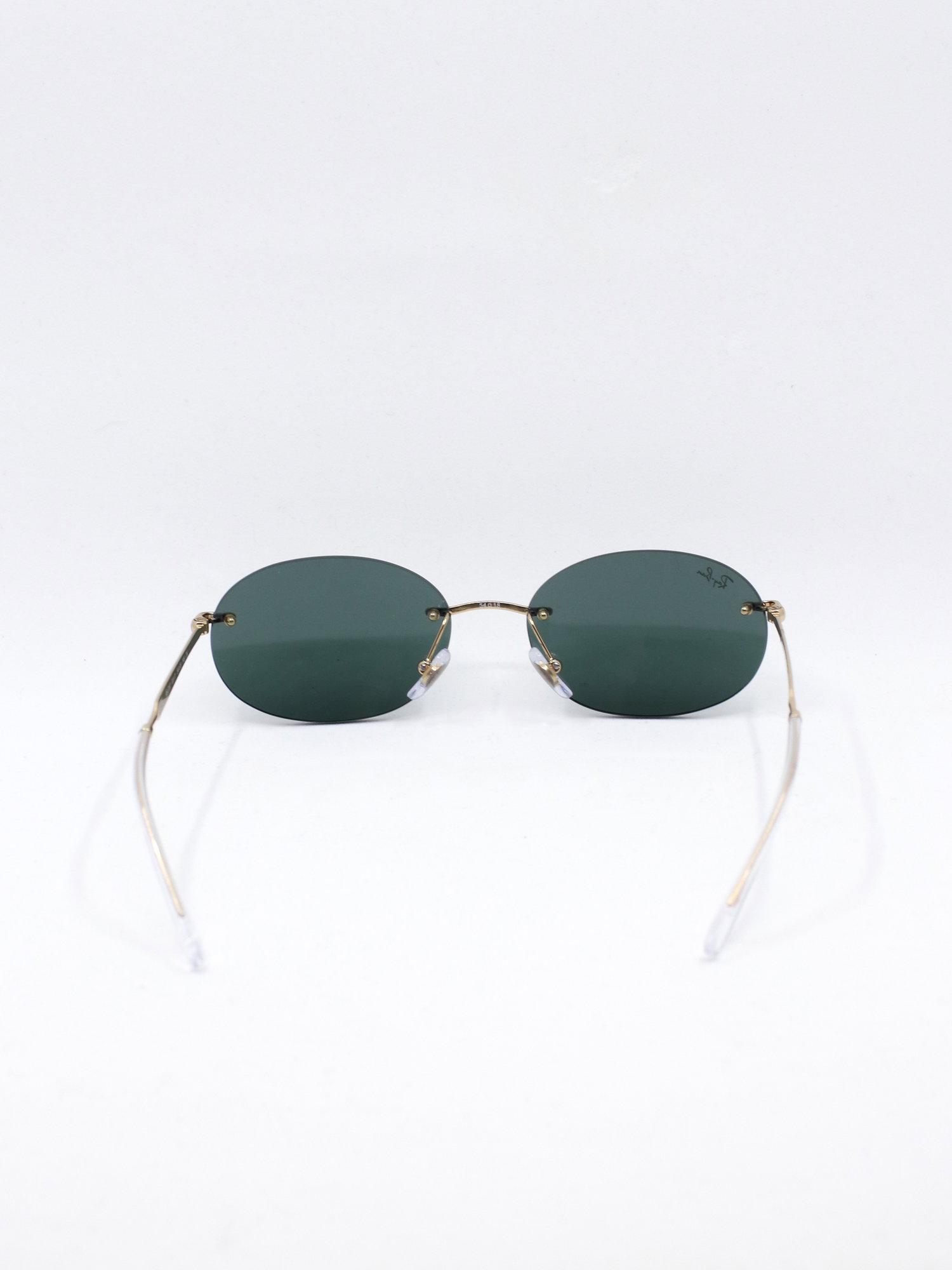 Oval rammeløs solbrille med metallstenger