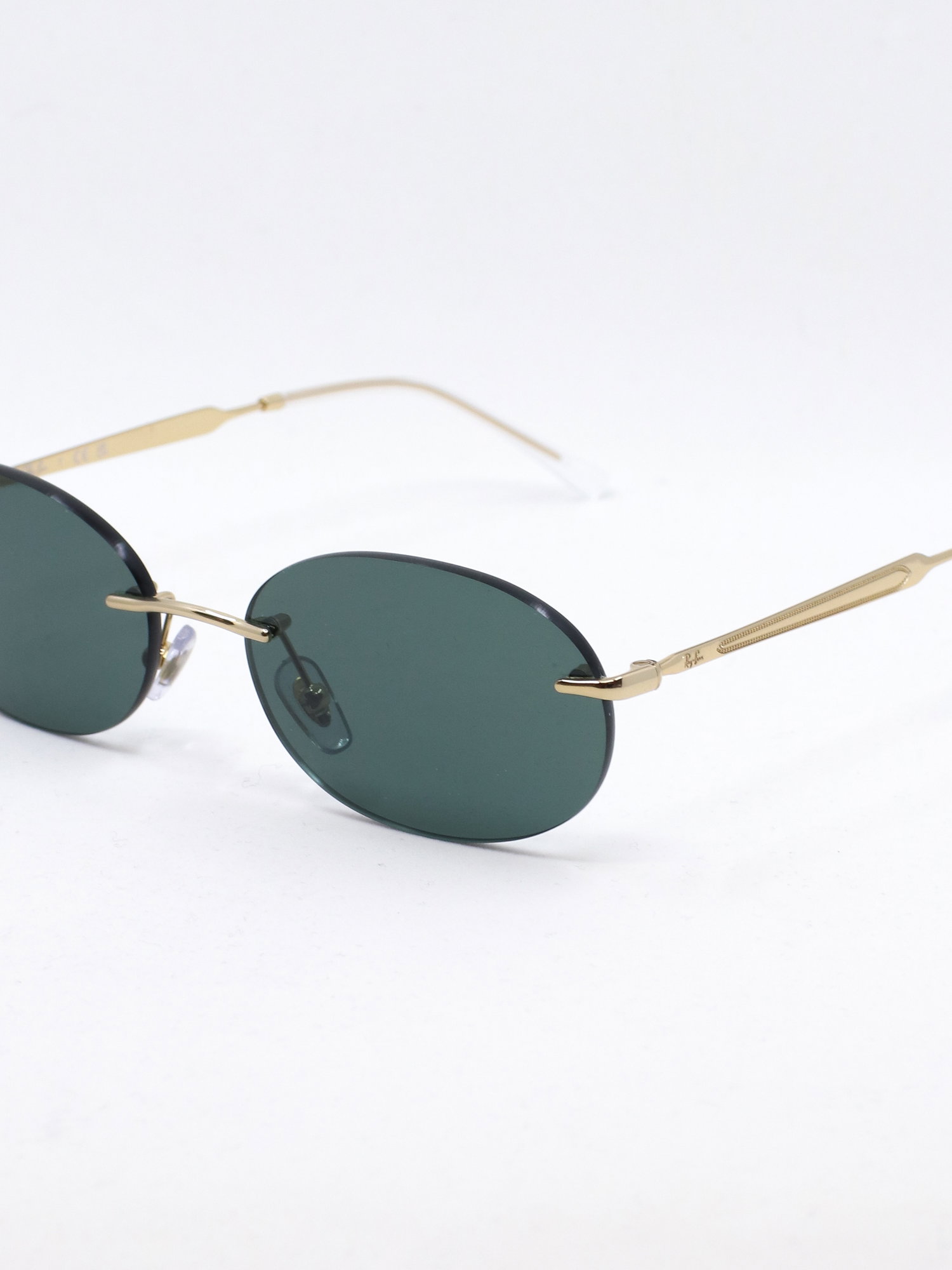 Oval rammeløs solbrille med metallstenger