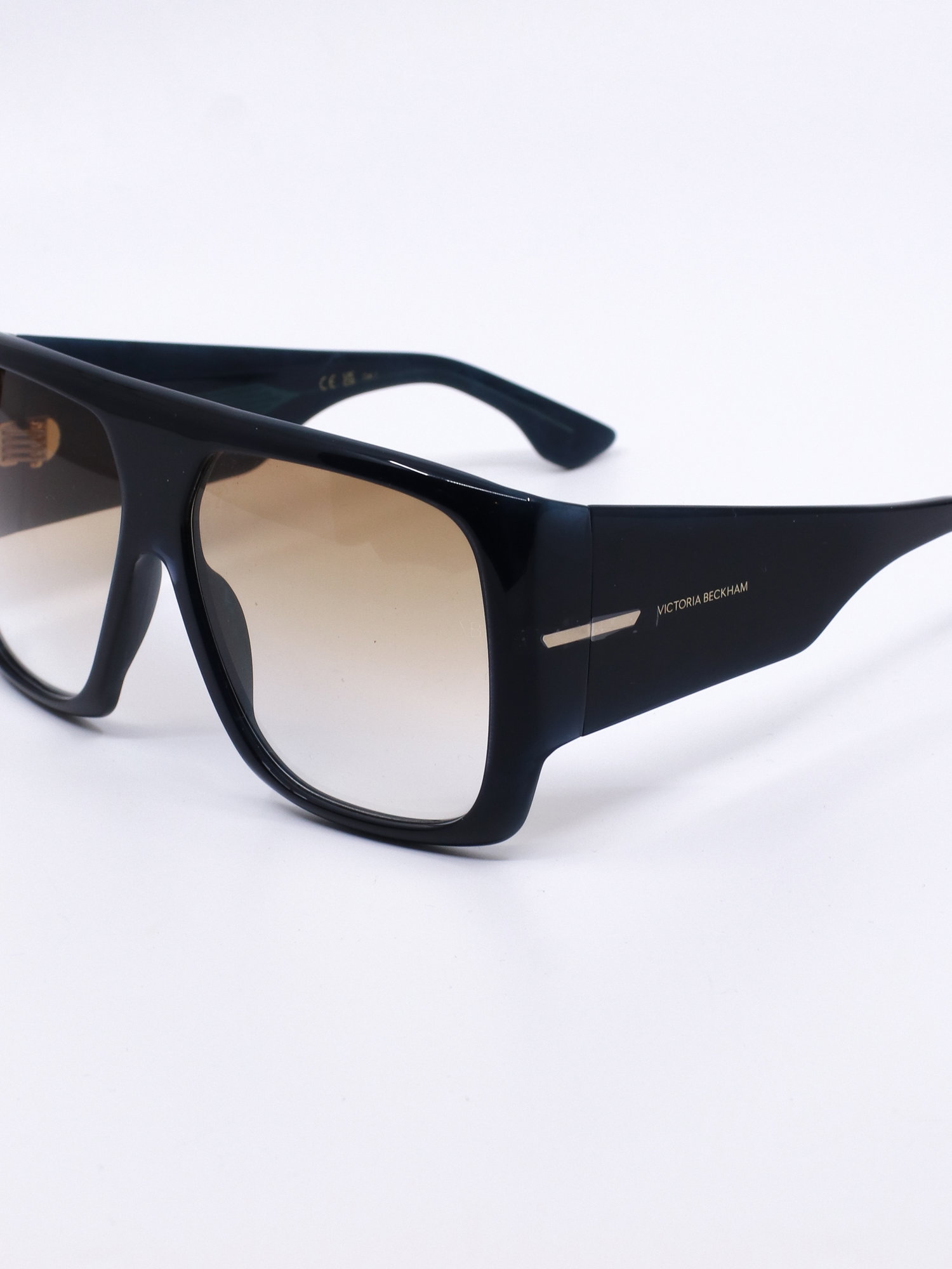 Solbrille med oversized fasong, kraftig svart ramme og brune, graderte glass