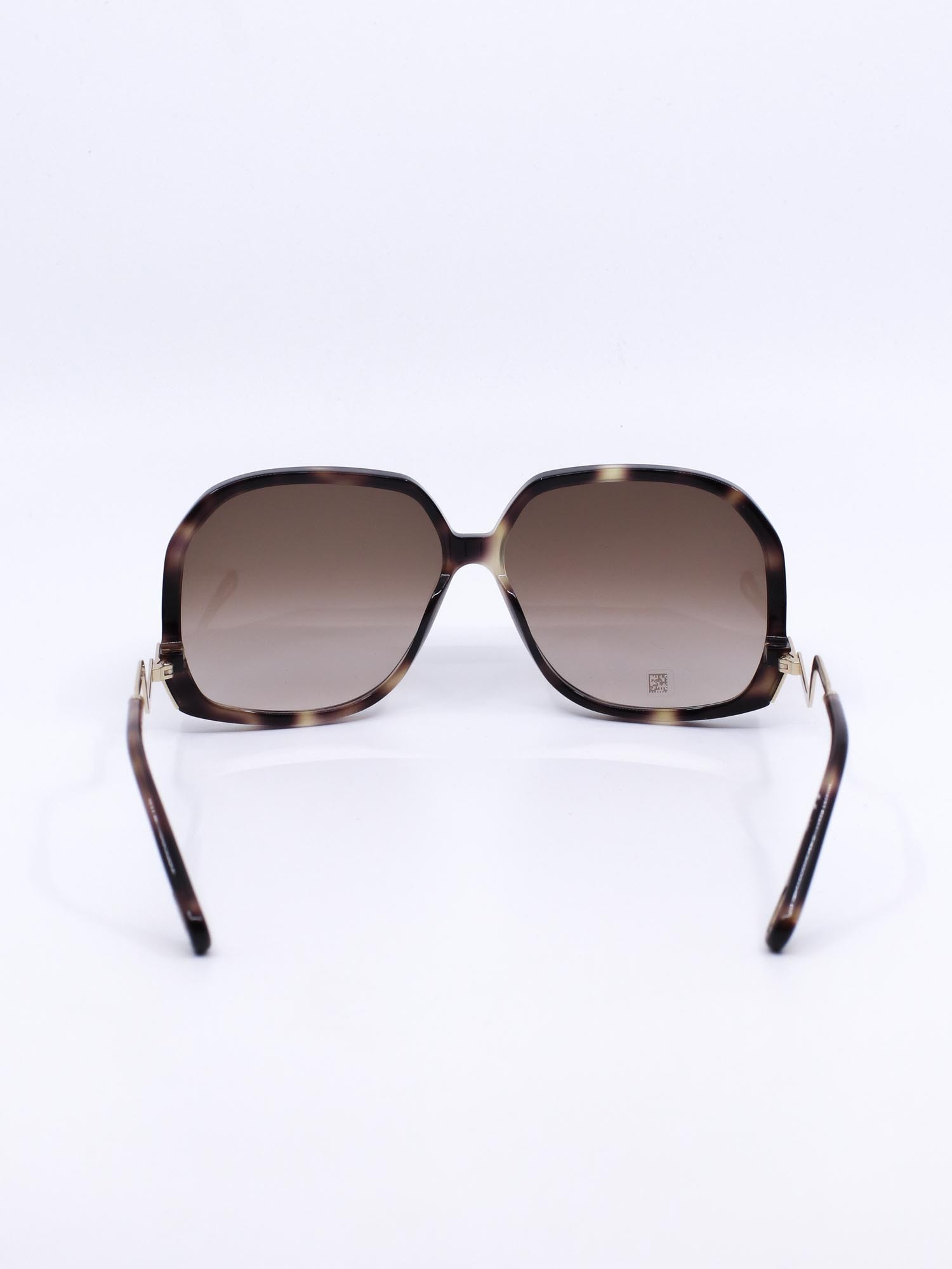 Oversized solbrille med organsik kvadratisk fasong og bølgede brillestenger