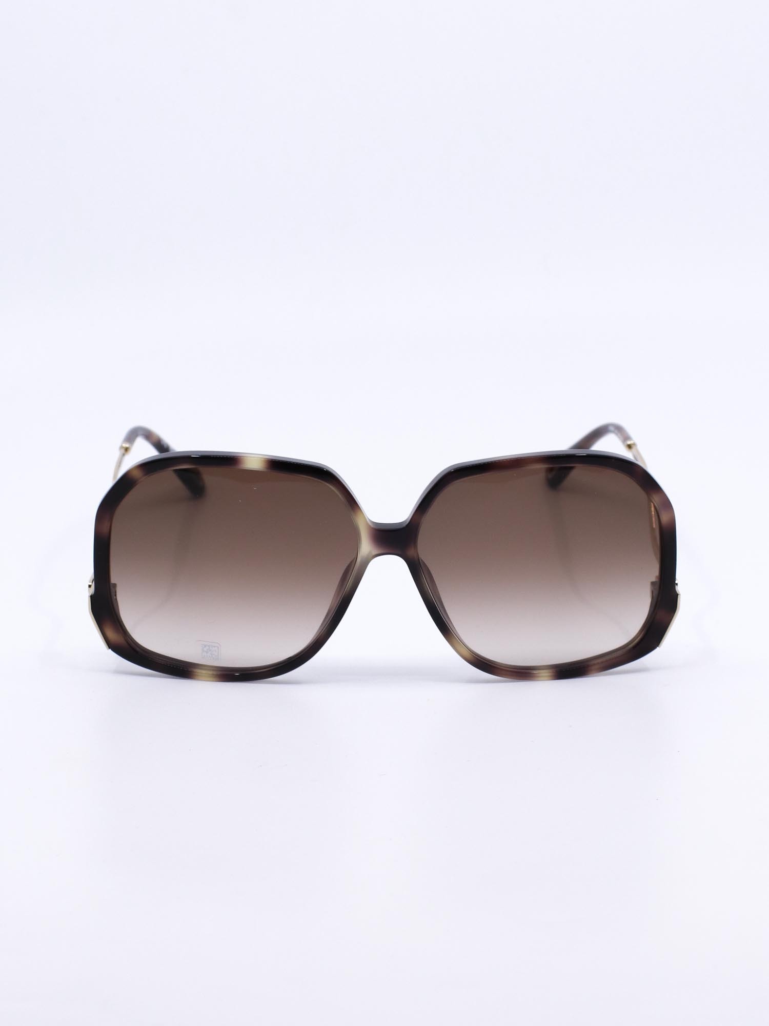 Oversized solbrille med organsik kvadratisk fasong og bølgede brillestenger