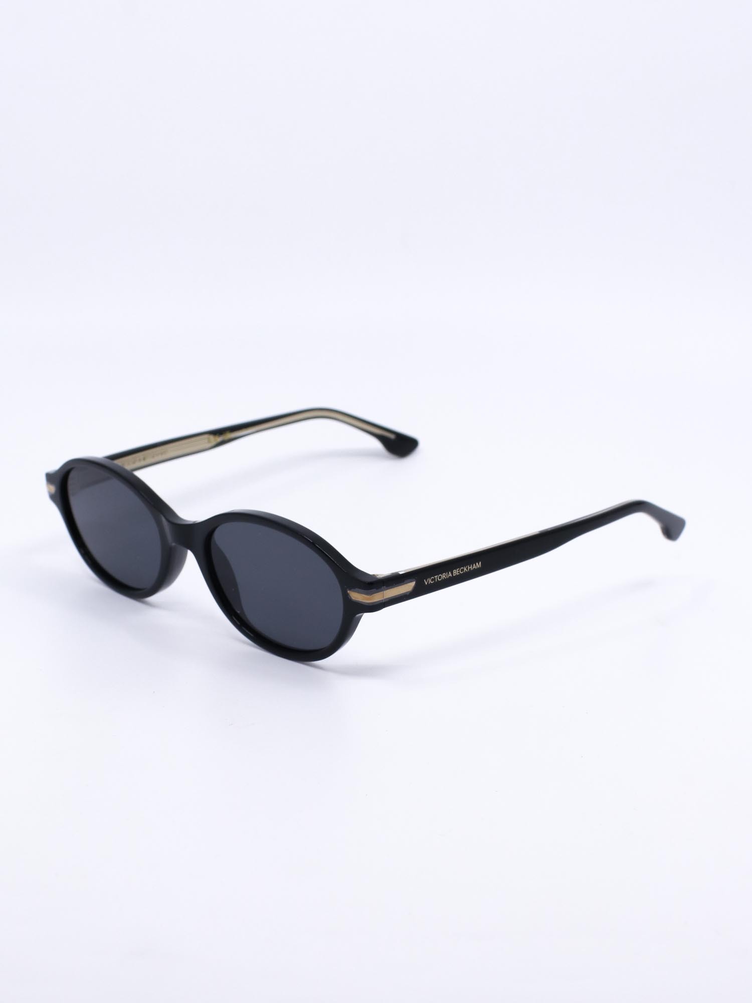 Oval solbrille med svart ramme og mørke glass